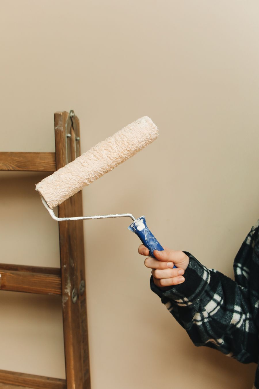 Painting supplies and a ladder set up for an interior job