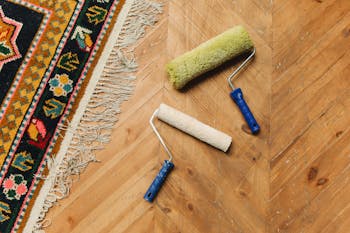 Paint Rollers Lying on a Wooden Floor 