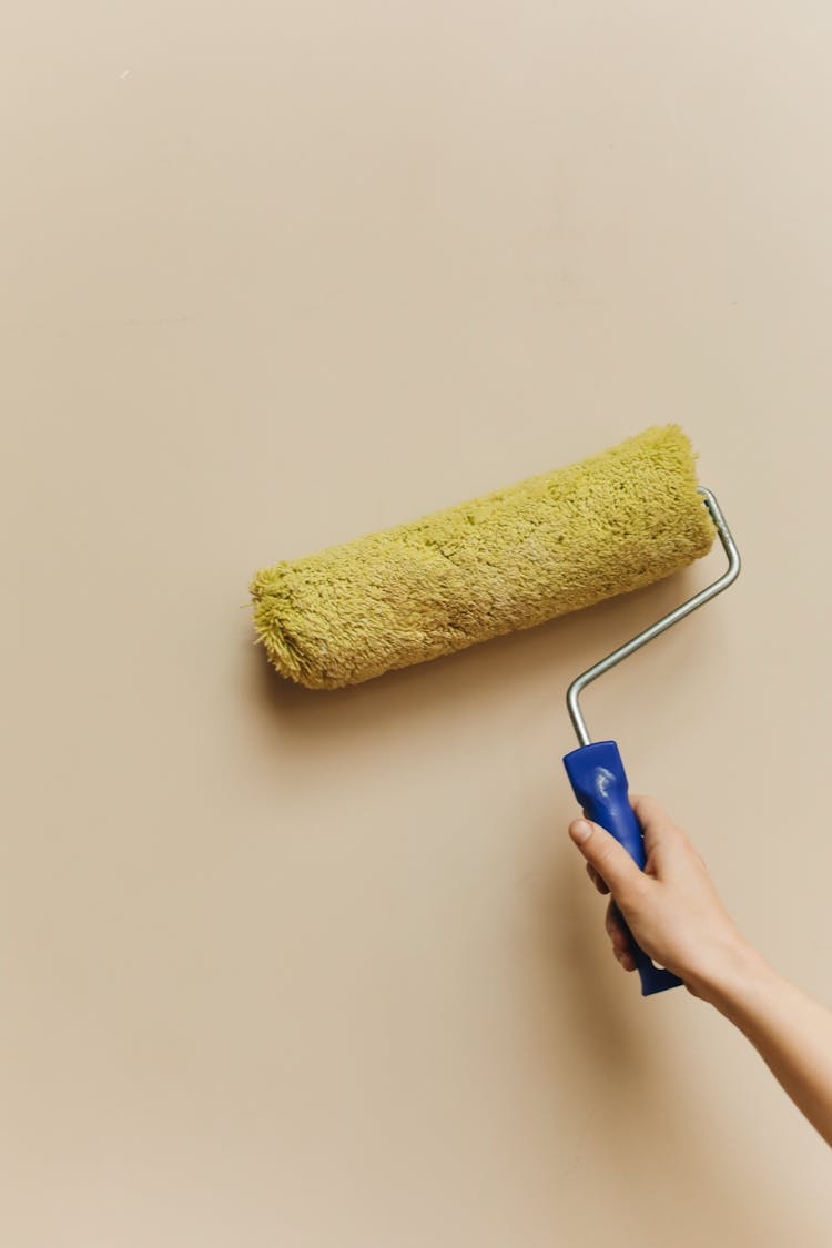 Woman Using Roller Paint Brush 