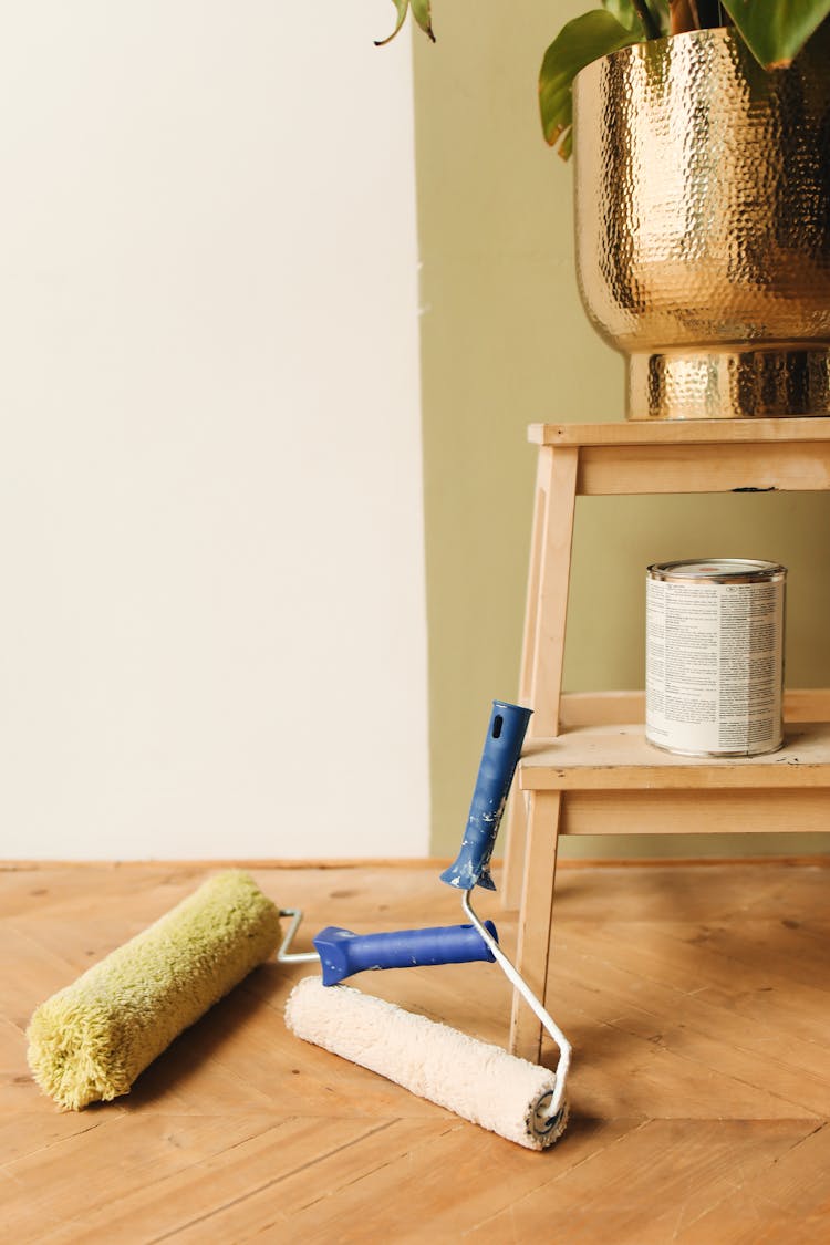 Paint Rollers On Wooden Floor