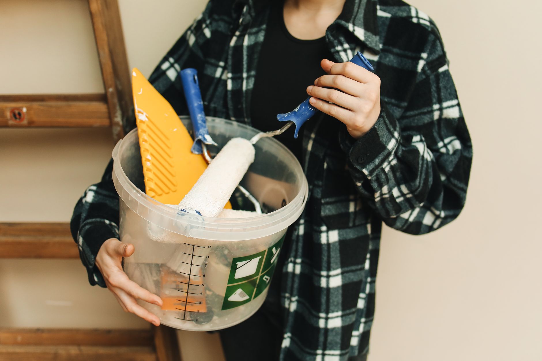 A Person Holding a Paint Roller,