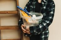A Person Holding a Bucket