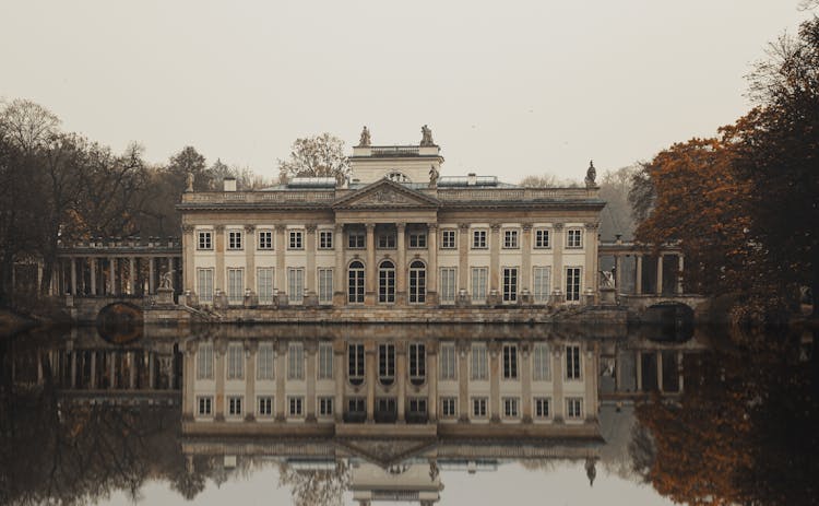 Reflection Of Concrete Building In The Water 