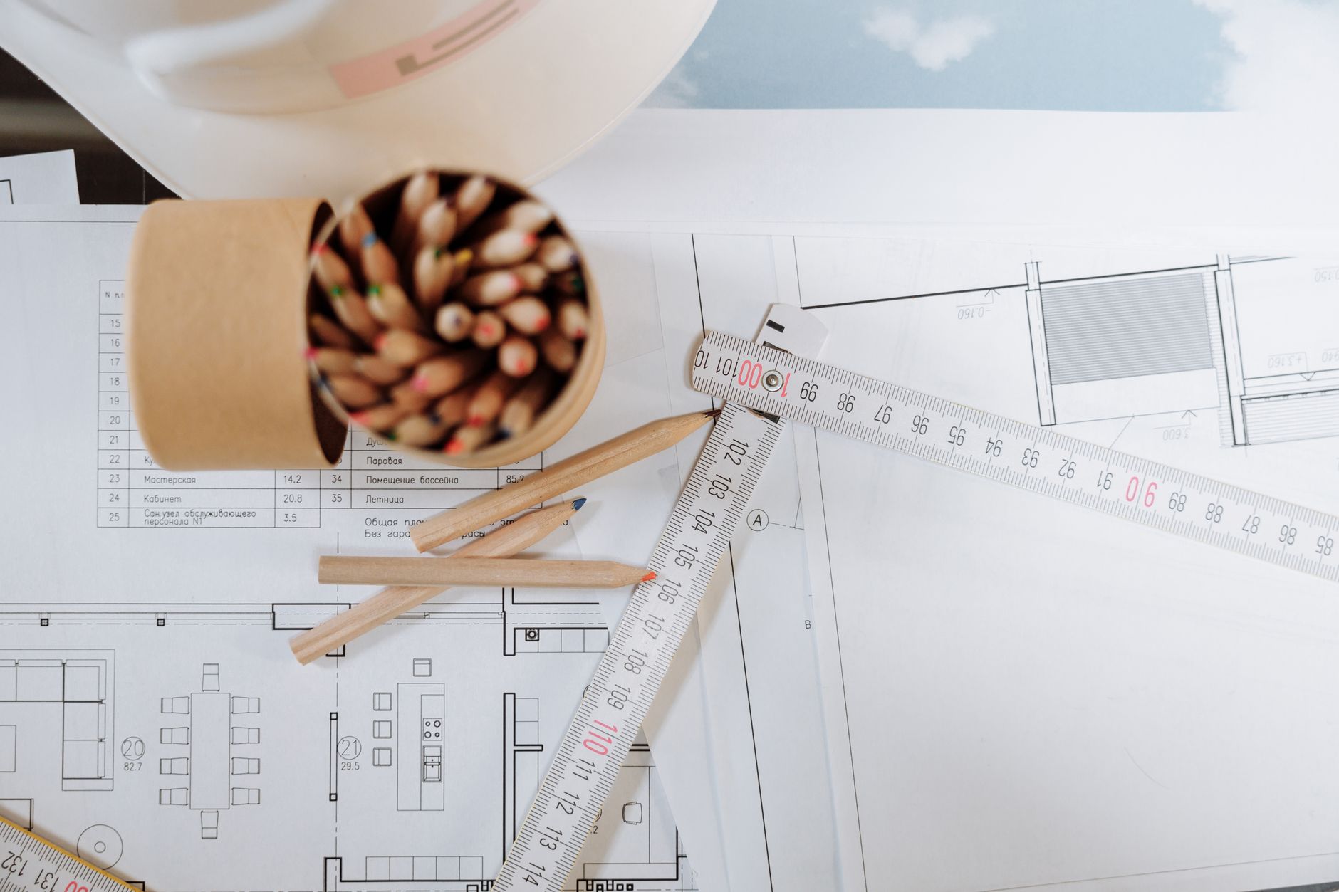 an architectural blueprint with a pencil and ruler laid across it