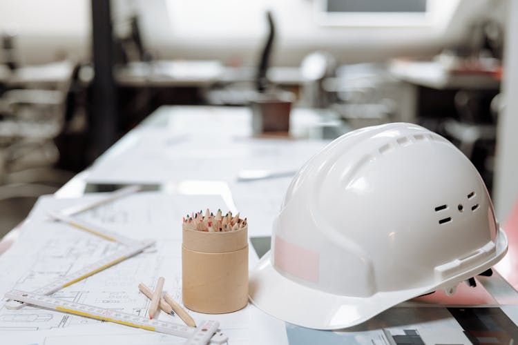 White Hard Hat Next To A Kraft Paper Jar