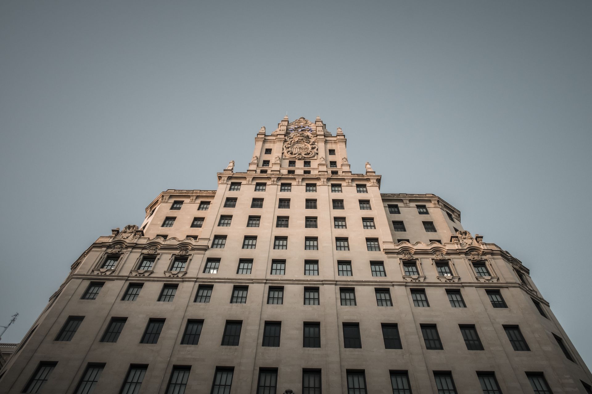 Stunning low-angle view of the iconic Telefonica Building facade in Madrid, Spain.
