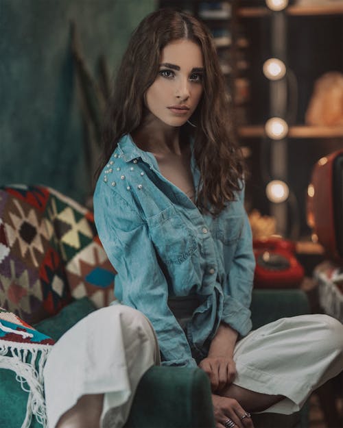 Woman sitting on chair in vintage room