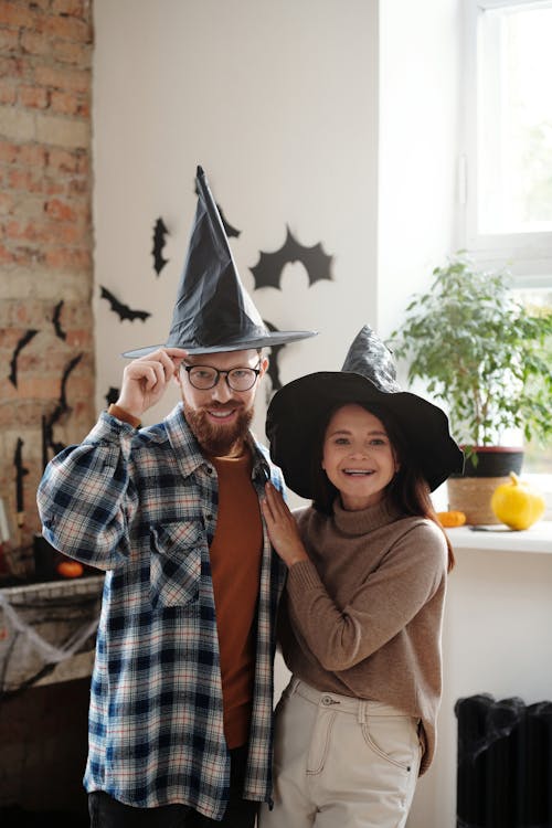 A Happy Couple Wearing Witch Hats