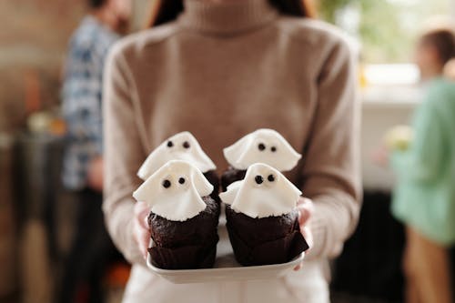 Woman Holding Chocolate Cupcakes On A Tray