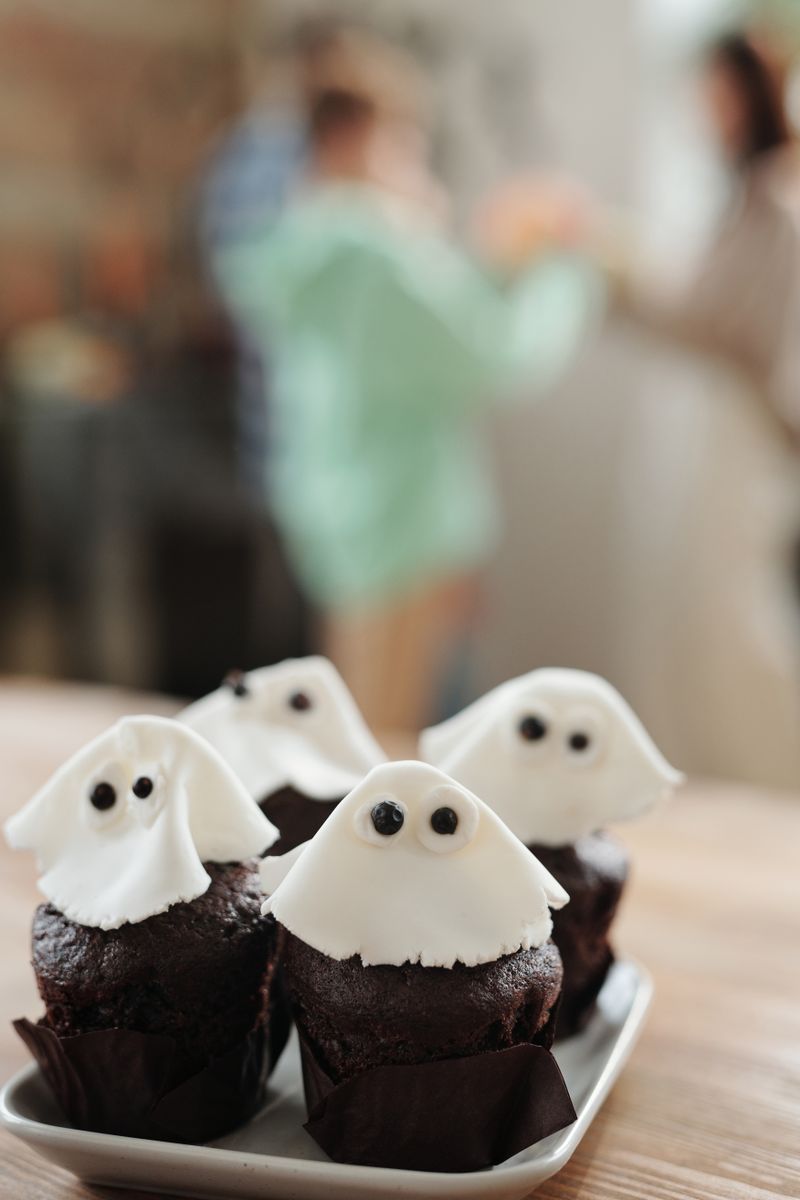 Chocolate cupcakes decorated with white ghost icing for a Halloween party