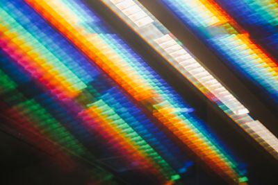A spectrum of rainbow light on a reflective surface — photo by Lars Mai on Pexels