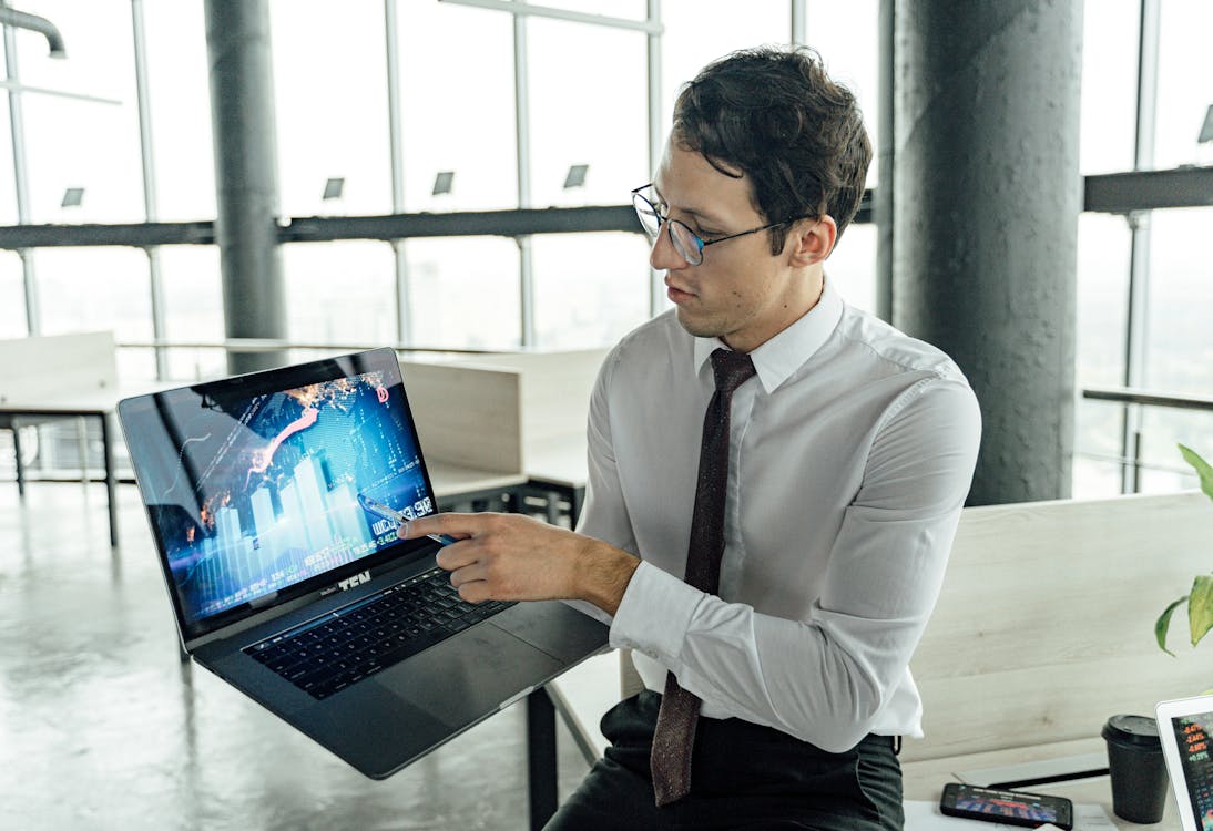 Free A Man Discussing using a Laptop Stock Photo
