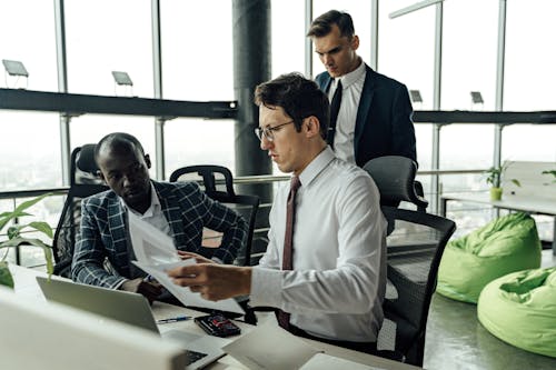 Three Men Working in the Office Together 