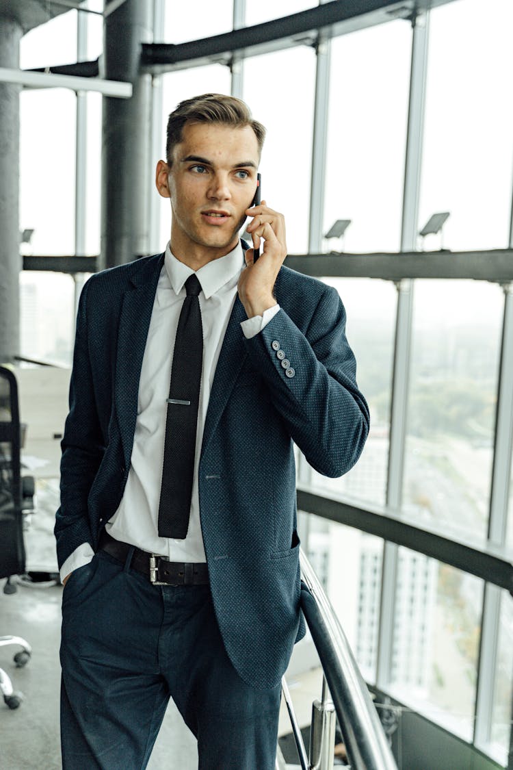 Man In Black Suit Talking On The Smartphone 