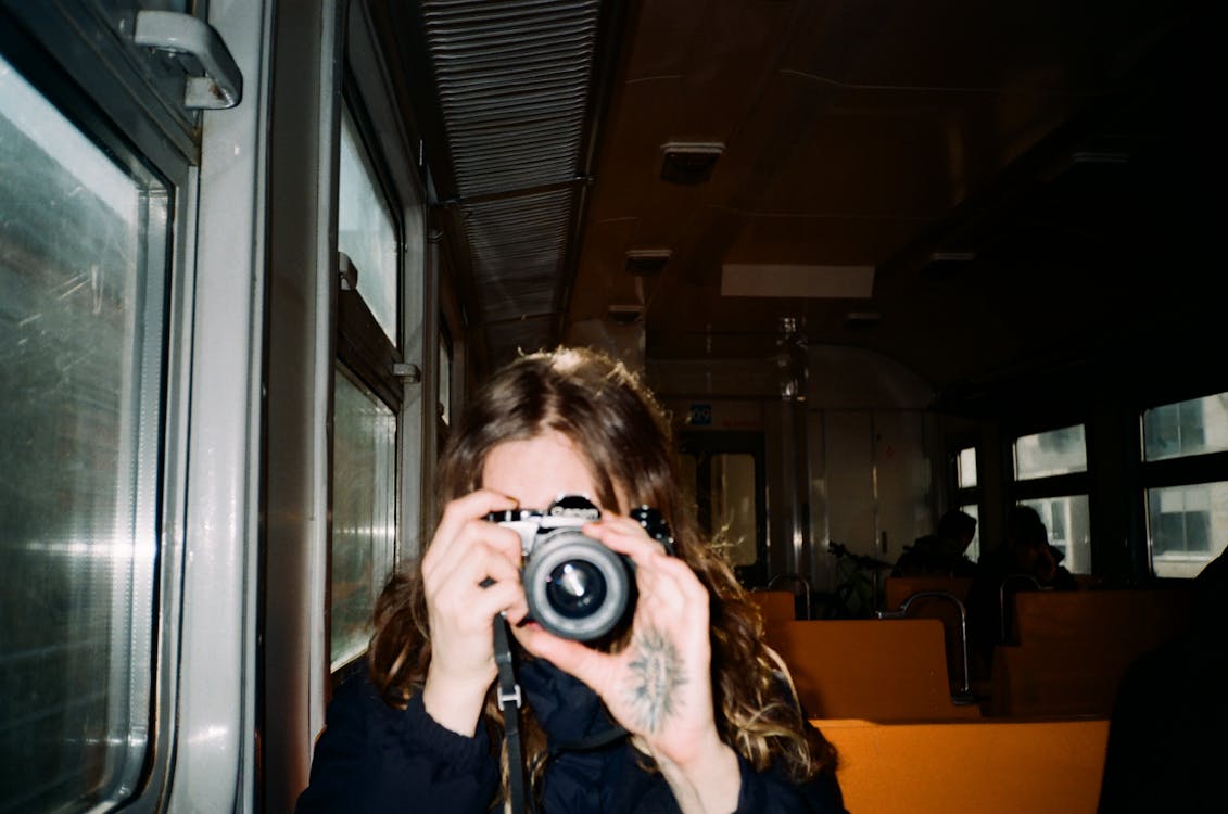 Free A Person Taking a Photo Using an Analog Camera Stock Photo