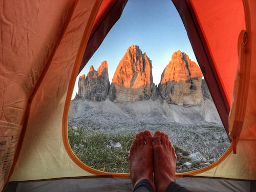 Free Person Inside Tent Near Mountains Stock Photo