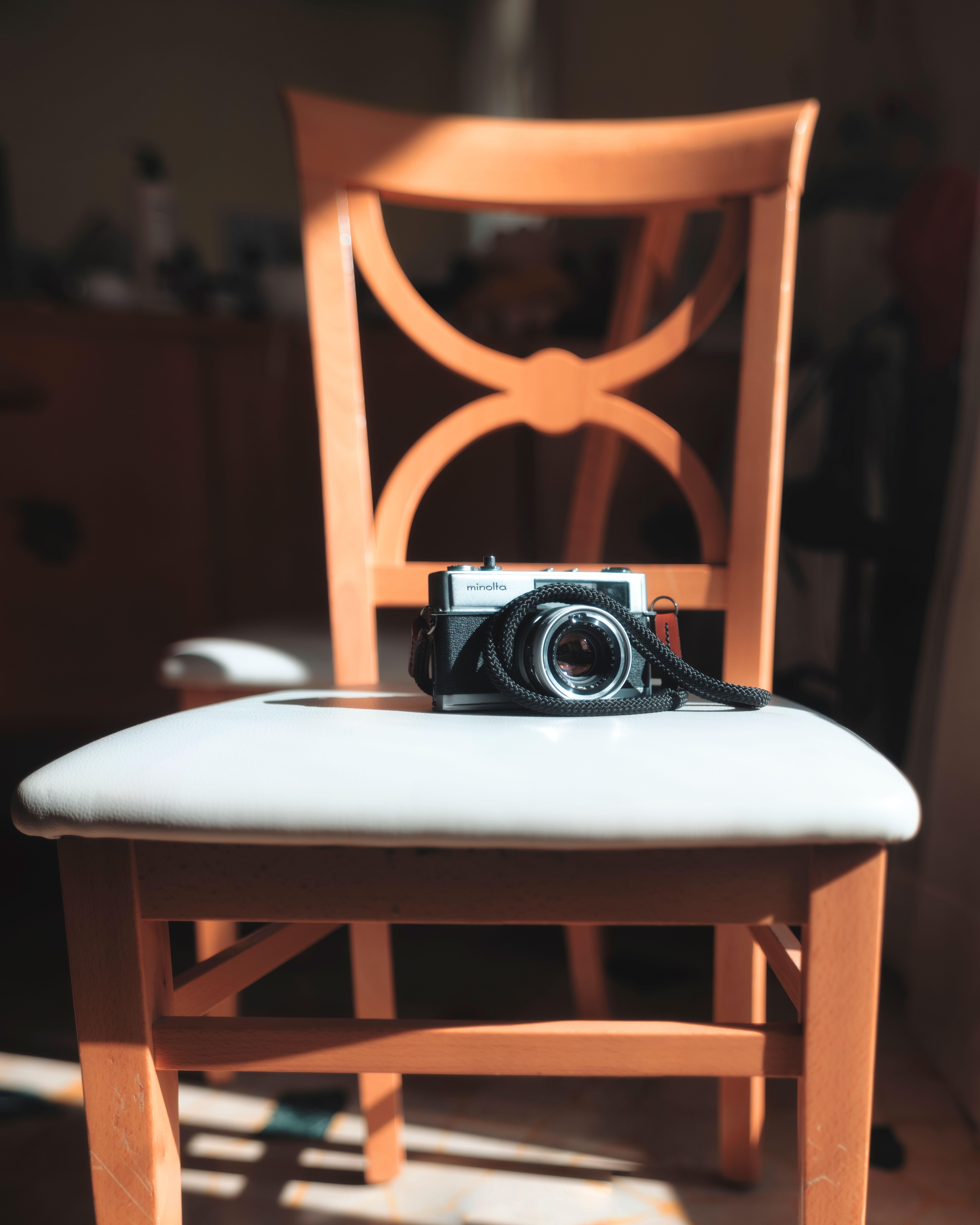 Vintage Camera on a Wooden Chair · Free Stock Photo
