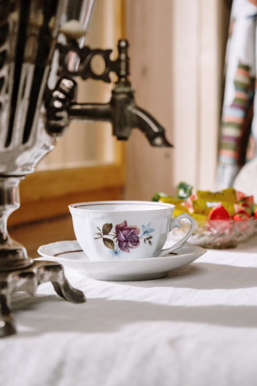 Close-Up Photo of a Porcelain Cup with Floral Design