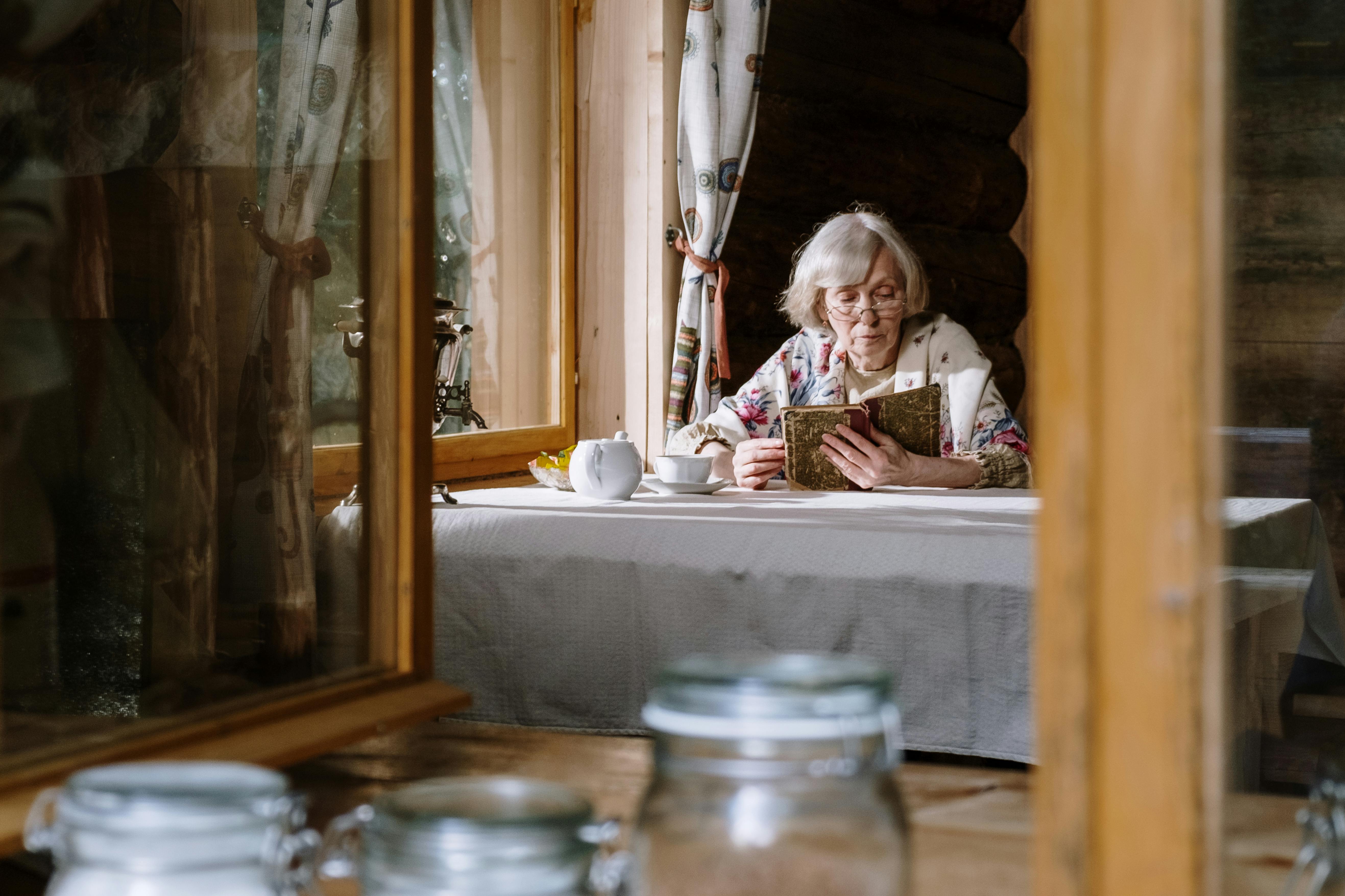 elderly woman reading on the table