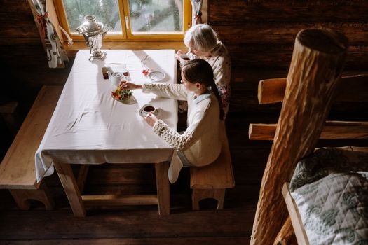 Grandmother and a Kid Having Tea