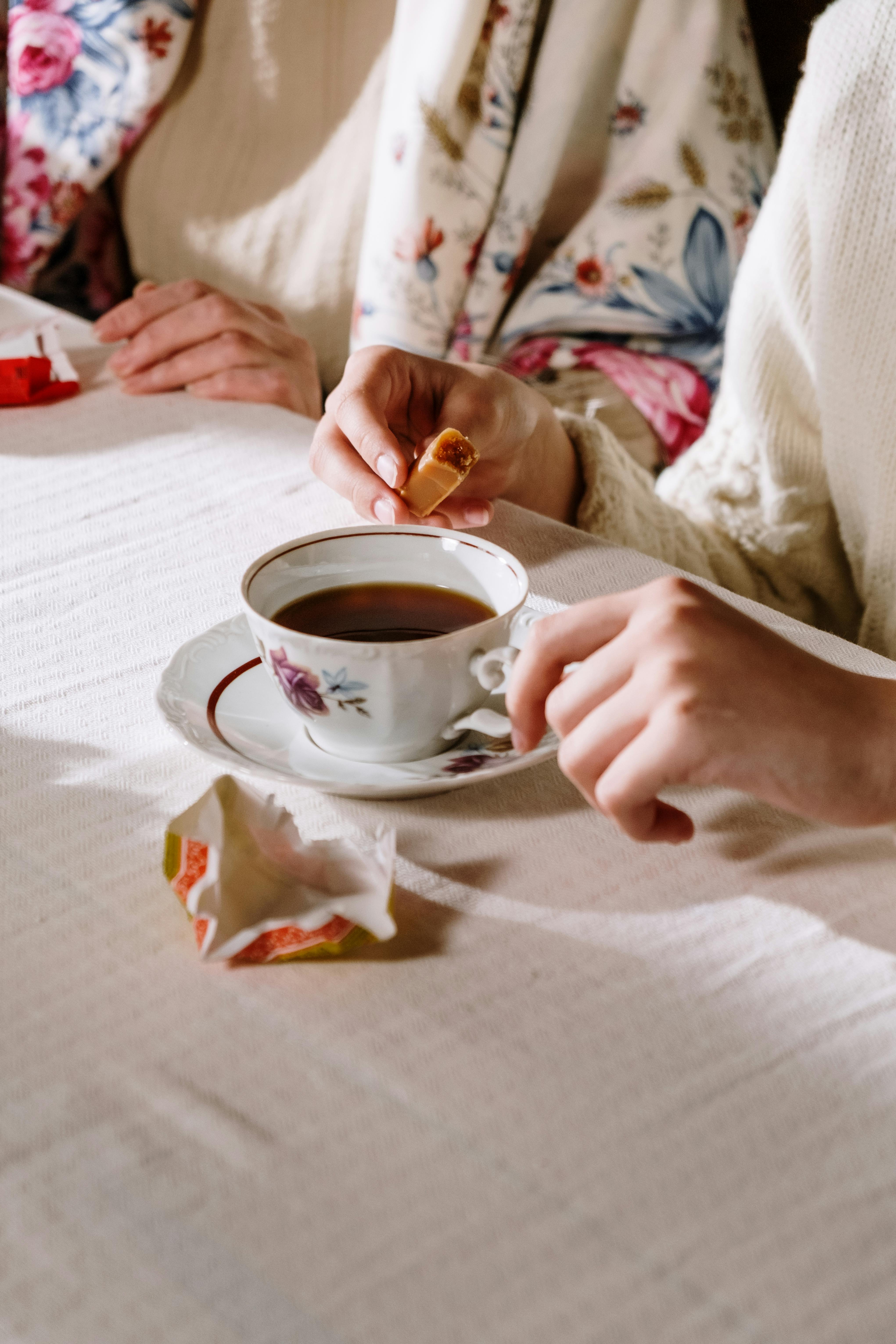 a person holding a cup of coffee