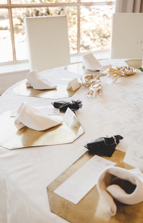Free Elegant wedding table setting with napkins and place cards in a sunlit room. Stock Photo
