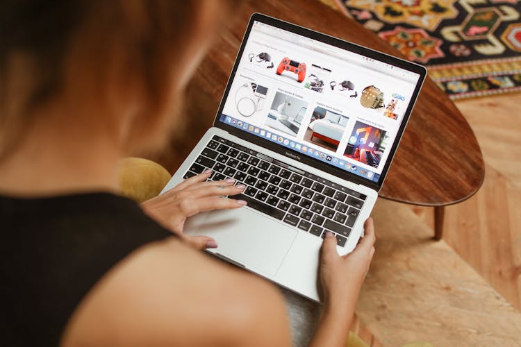 A Person Shopping Online Using A Laptop 