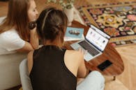 Woman in Black Tank Top Using Macbook Pro