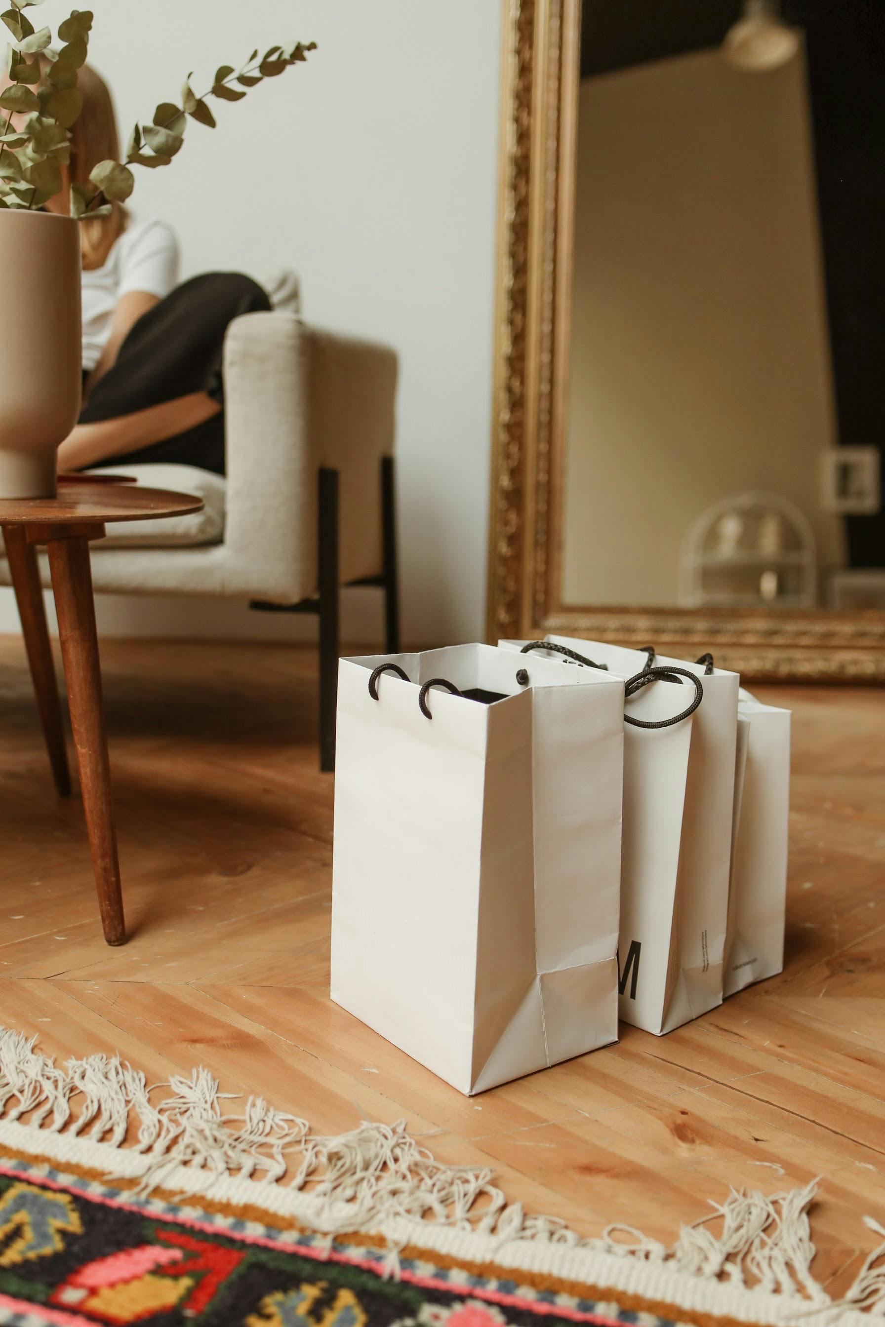 木地板上摆放着购物袋，并设有镜面反射区和舒适的休息区