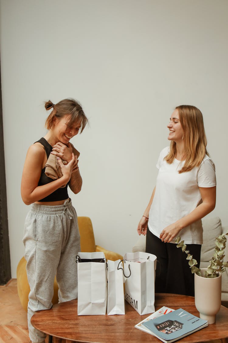 Woman In Black Tank Top And Gray Pants Hugging Brown Textile