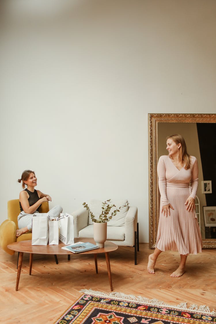 Barefooted Woman Trying On Beige Plitted Dress 