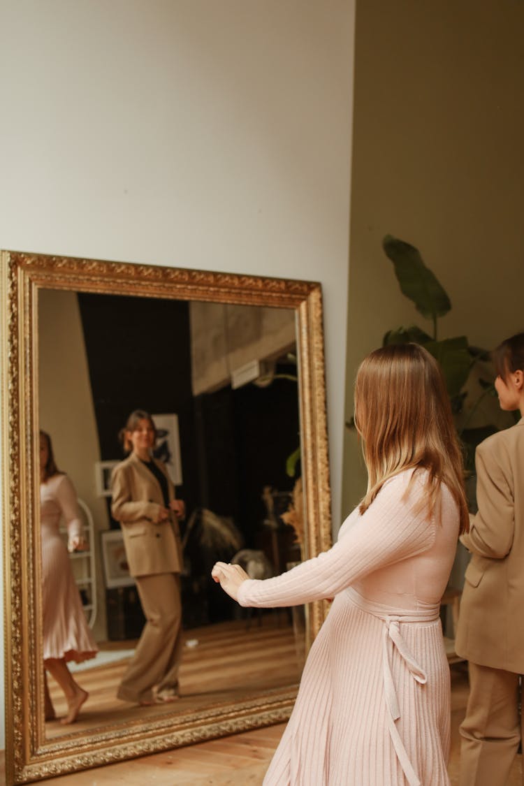 Mirror Images Of Women Standing In Front Of Mirror