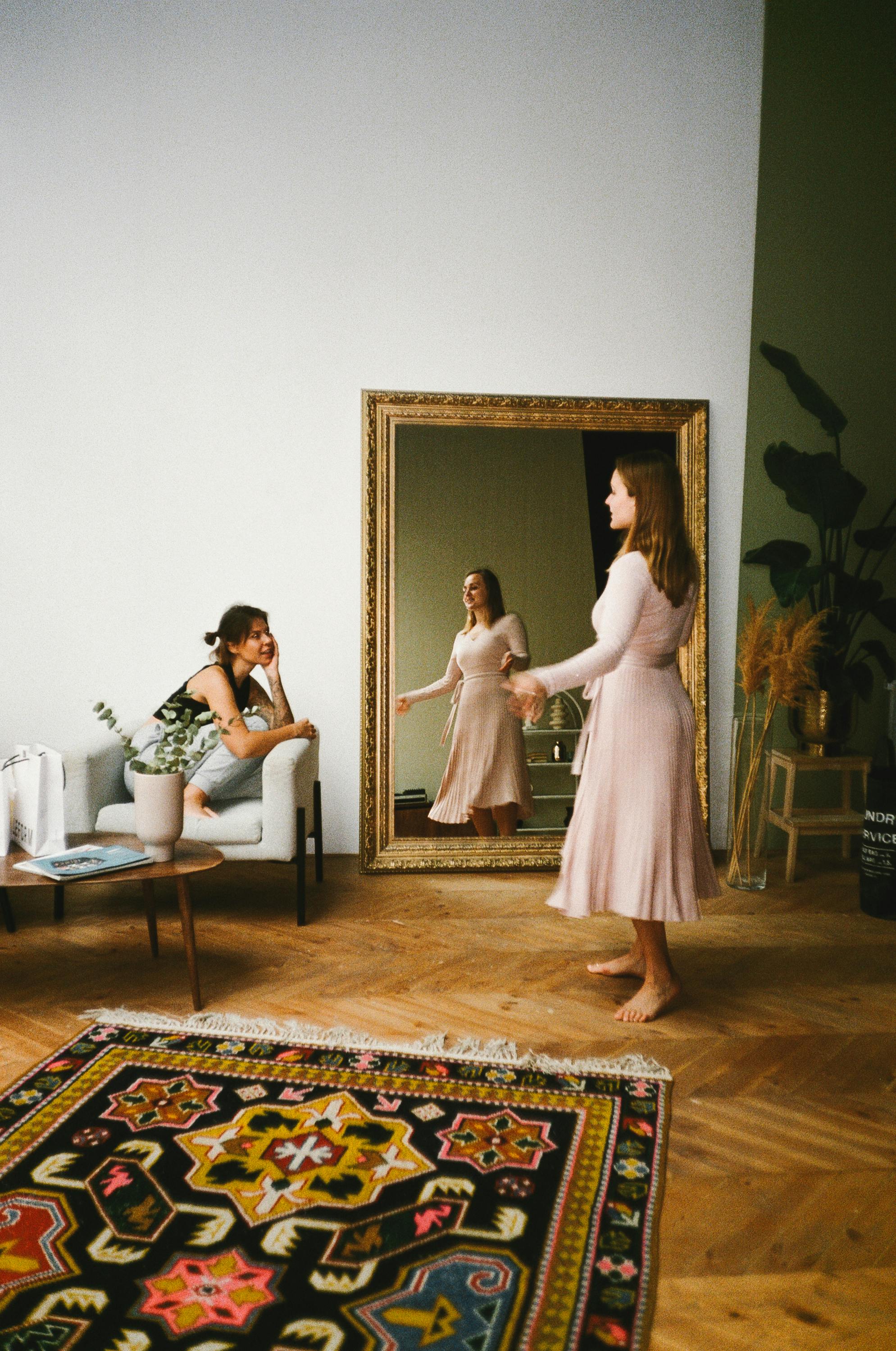 a woman in pink dress while talking her friend