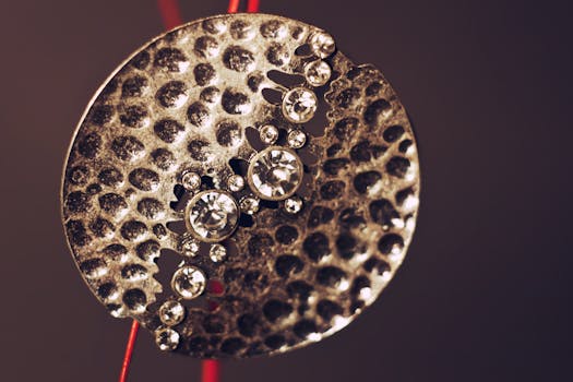 Close-up shot of a modern metallic pendant adorned with sparkling crystals, perfect for jewelry designs.