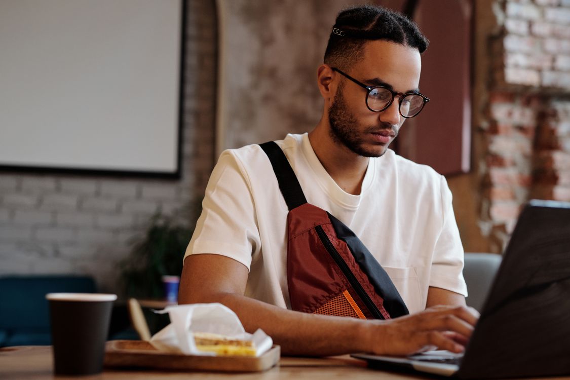 A Man Typing on His Laptop · Free Stock Photo