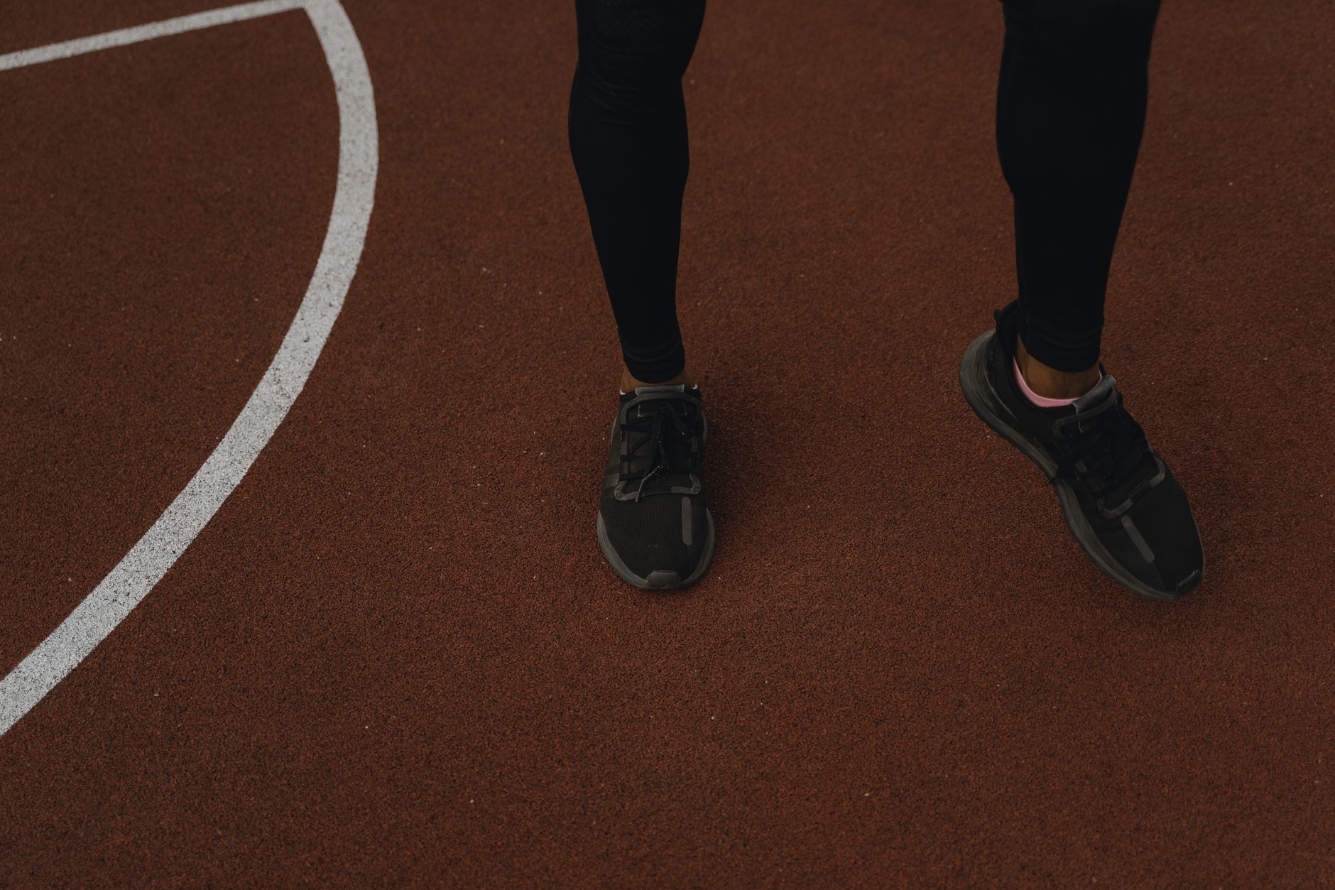 Close-up of sports shoes on a running track, perfect for fitness themes.