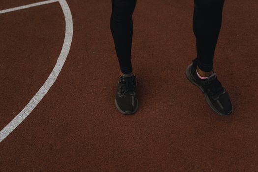 Close-up of sports shoes on a running track, perfect for fitness themes.