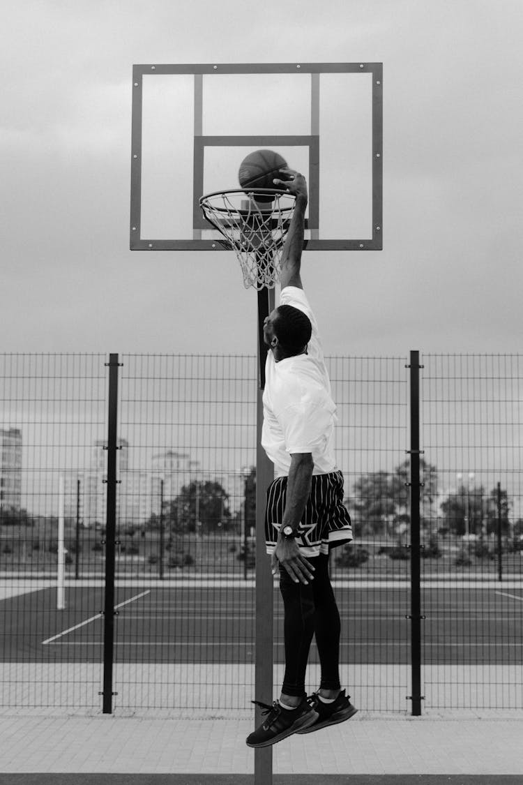 A Man Dunking A Basketball