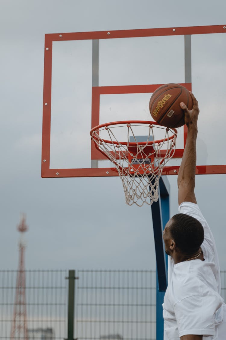 A Man Dunking A Basketball 