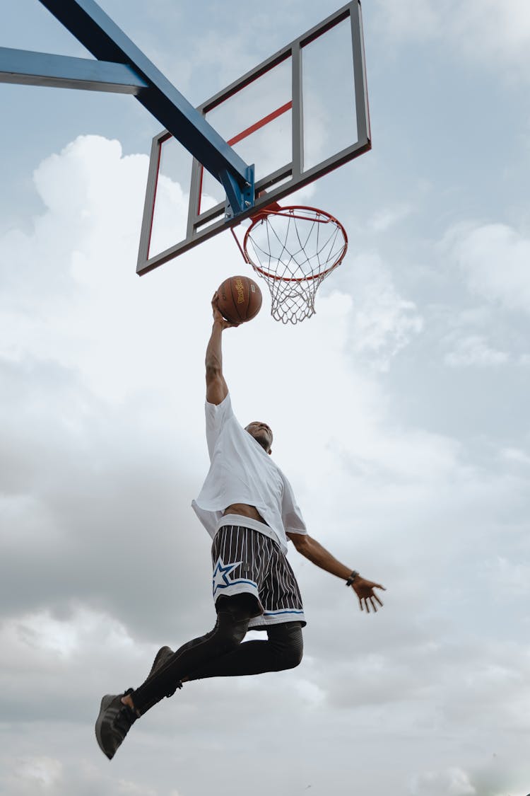 A Man Doing A Dunk