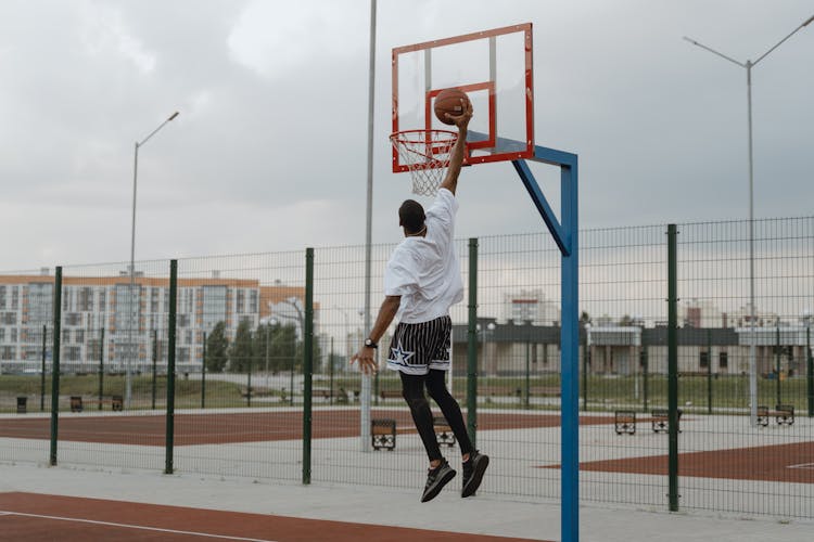 A Man Doing A Dunk