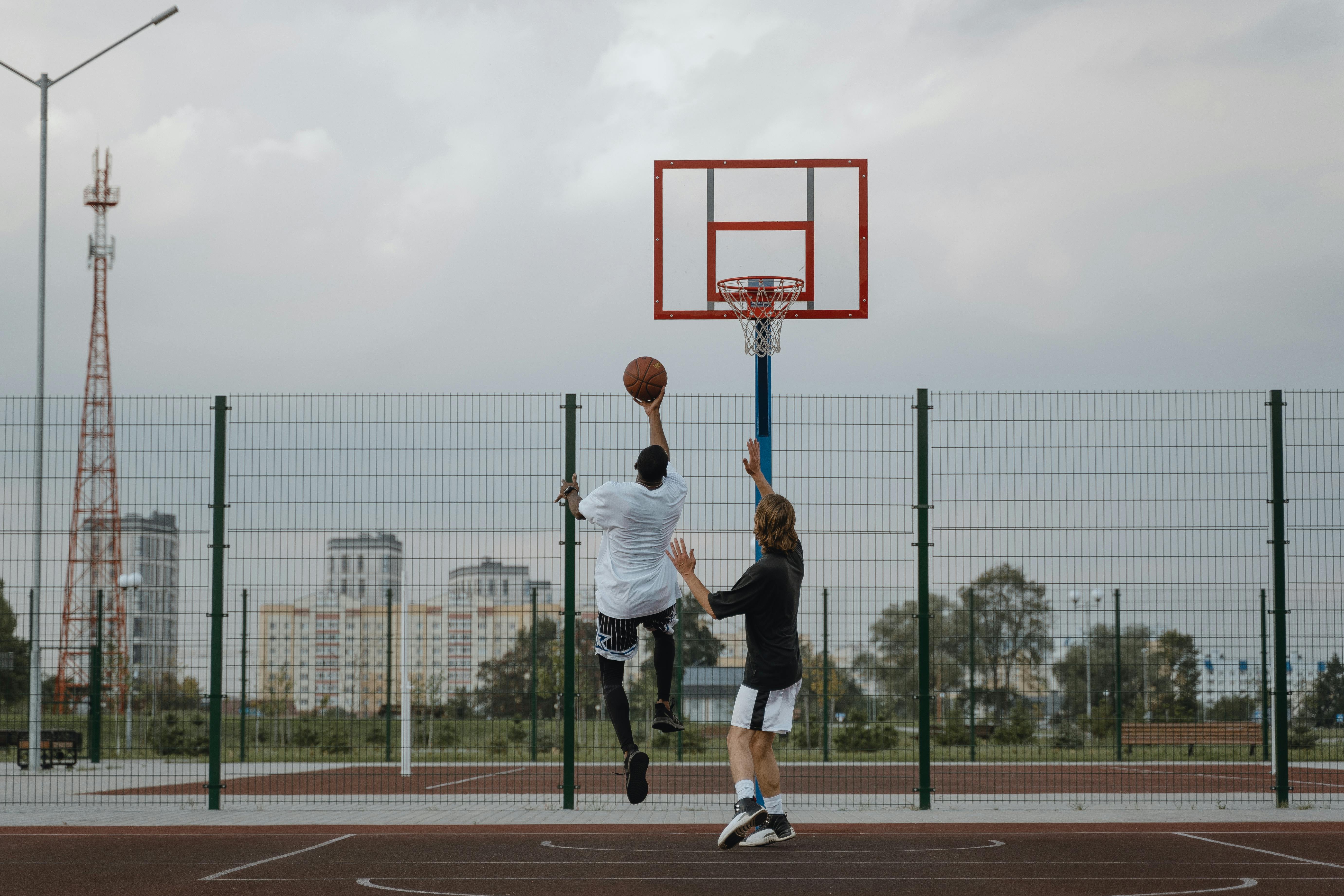 Man in White Shirt and Black Shorts Playing Basketball \u00b7 Free Stock Photo