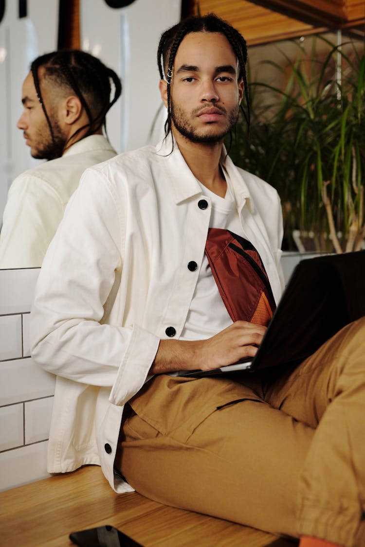 Man In White Jacket Leaning On Wall Mirror