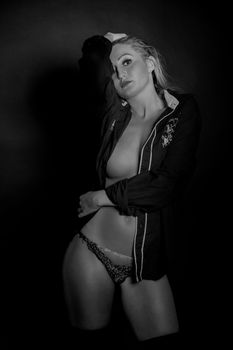 Stylish black and white studio portrait of a woman in lingerie, capturing elegance and beauty.