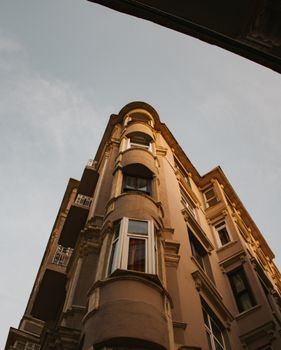A low-angle view of a classic building against a clear sky, showcasing elegant architectural details.