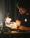 Man Repairing Analog Camera
