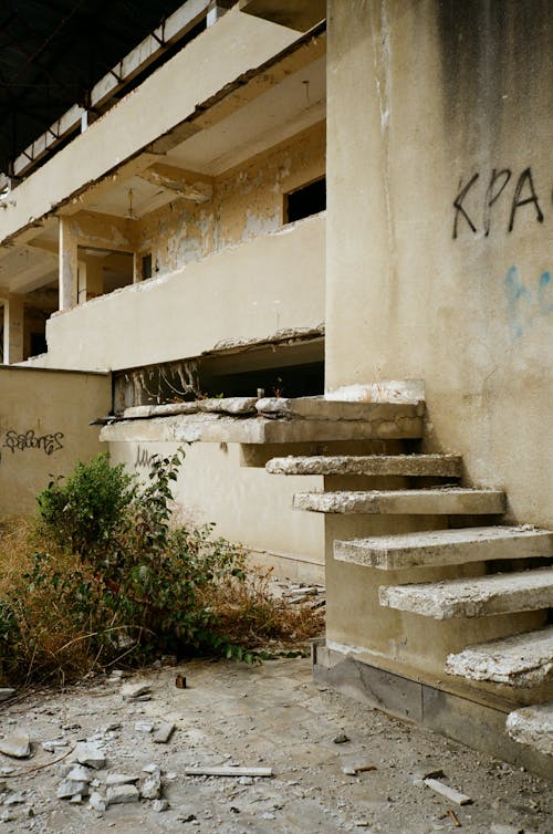 Old house with damaged stairs in town