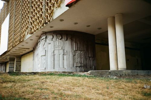 Free Old house facade with columns and carved ornament on wall near grass meadow in city Stock Photo