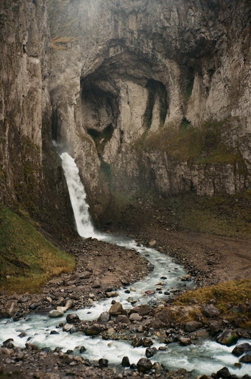 Waterfall with fast foamy flow in mountains