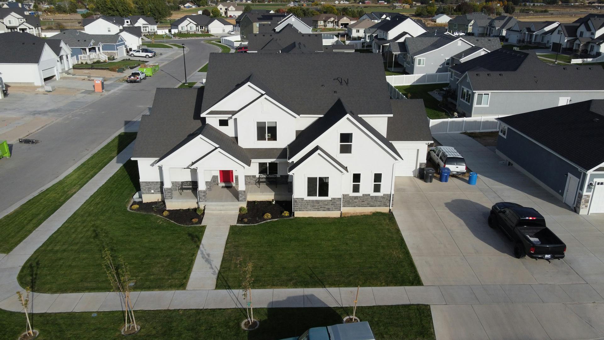 Aerial view of a modern suburban home in Spanish Fork, Utah, showcasing a neat neighborhood layout.